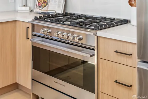 a kitchen with a table chairs sink and cabinets