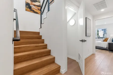 a view of a livingroom with wooden floor and white walls