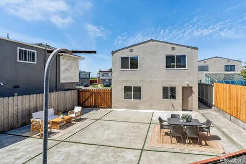 a outdoor dining space with furniture and wooden floor