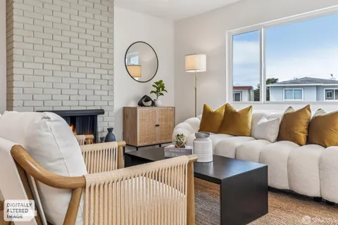 a living room with furniture a window and a fireplace