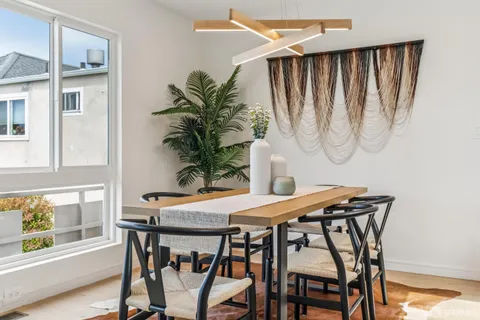 a view of a dining room with furniture and window