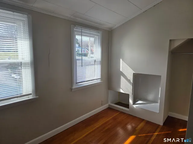 a bathroom with a granite countertop sink a mirror and shower