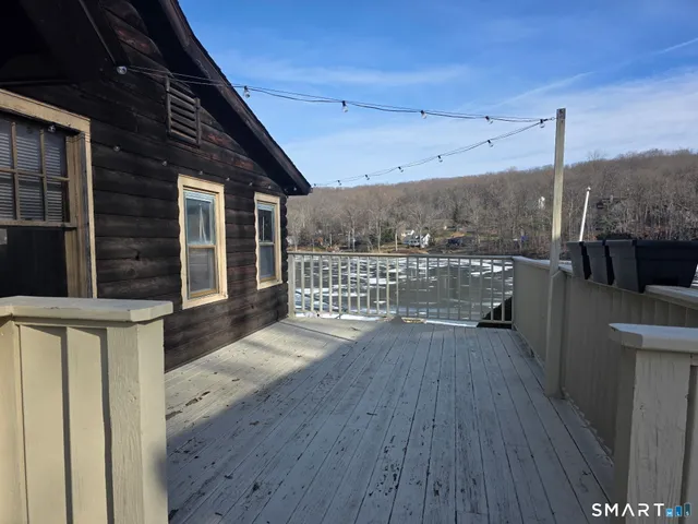 a view of a balcony with wooden floor