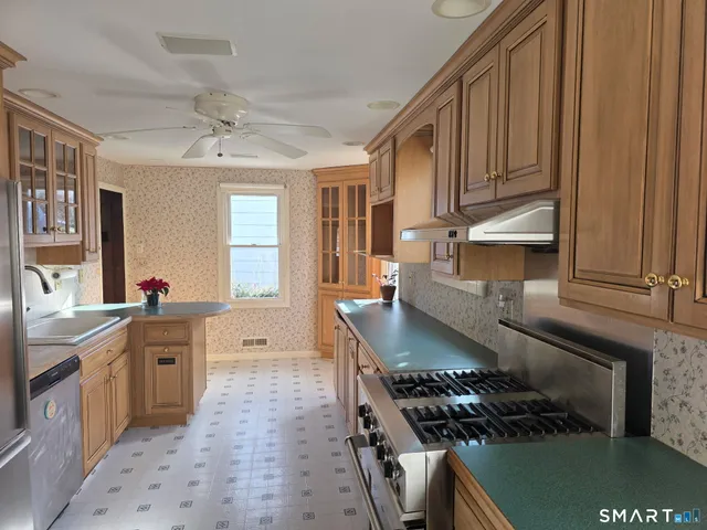a view of a kitchen with granite countertop a sink and cabinets