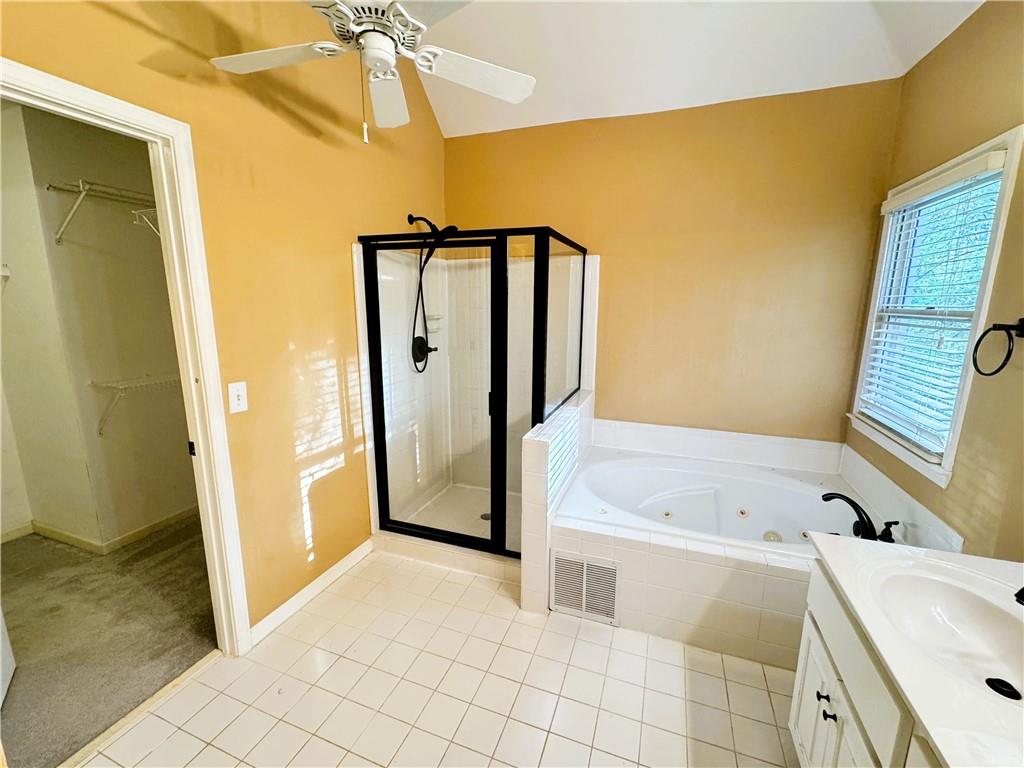 2550 Wellsley Lane Cumming, GA 30041 - Photo 12 of 19 a bathroom with a tub a sink and a mirror