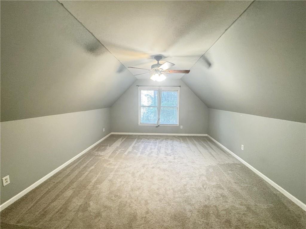 2550 Wellsley Lane Cumming, GA 30041 - Photo 15 of 19 an empty room with a chandelier fan and windows
