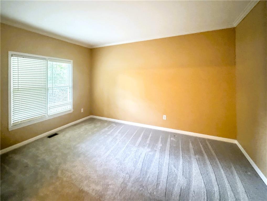 2550 Wellsley Lane Cumming, GA 30041 - Photo 10 of 19 an empty room with wooden floor and windows