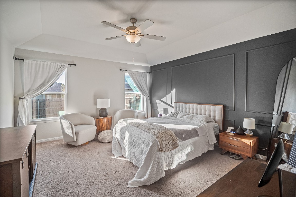 9905 Comely Bend Manor, TX 78653 - Photo 13 of 22 Bedroom featuring a decorative wall, ceiling fan, carpet flooring, and lofted ceiling