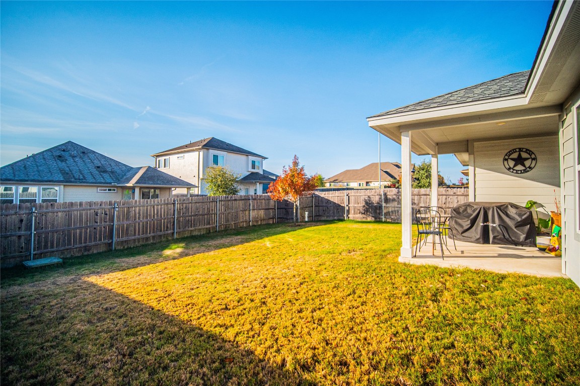 9905 Comely Bend Manor, TX 78653 - Photo 19 of 22 Fenced backyard featuring a patio and a residential view