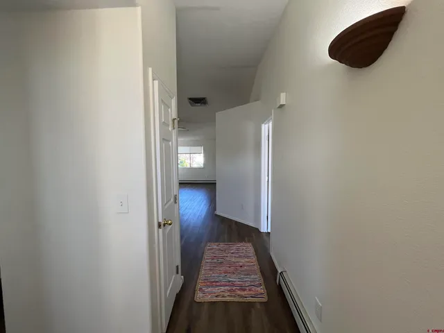 a kitchen with a sink stove and wooden floor