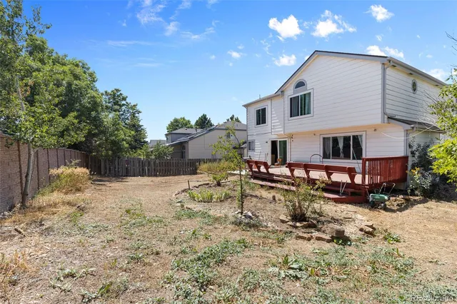 a view of a house with a yard covered in snow
