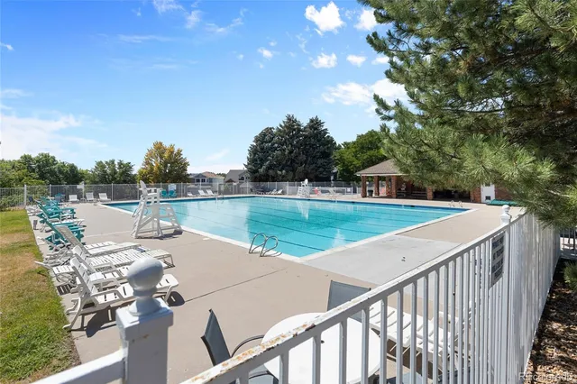a view of a lake with couches and wooden floor