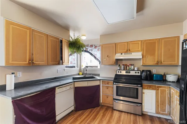a kitchen with stainless steel appliances a sink stove and cabinets