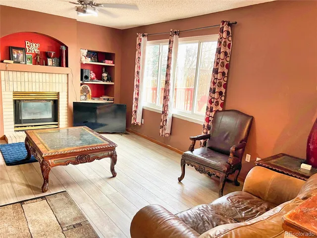 a living room with furniture and a fireplace