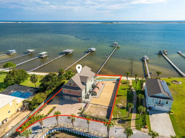 an aerial view of a house with a ocean view