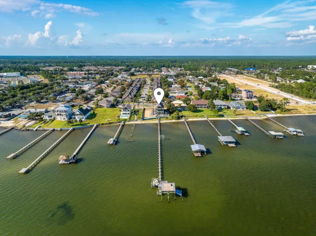 a view of a balcony with wooden floor and outdoor seating