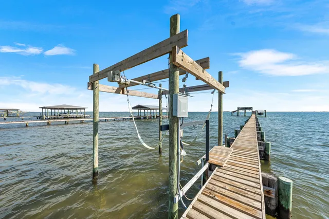 an empty room with wooden floor and furniture