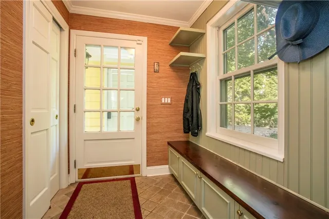 a view of a bedroom with wooden floor and a window
