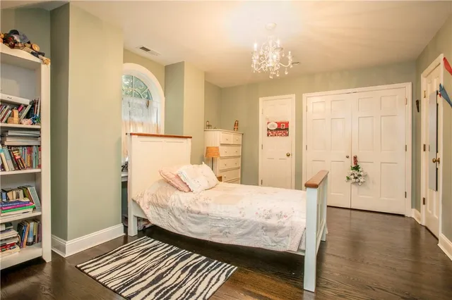a bedroom with a bed and a book shelf