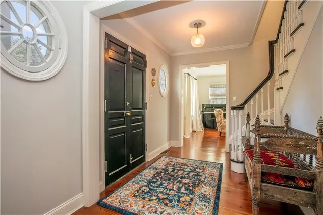 a view of a hallway with wooden floor and workspace