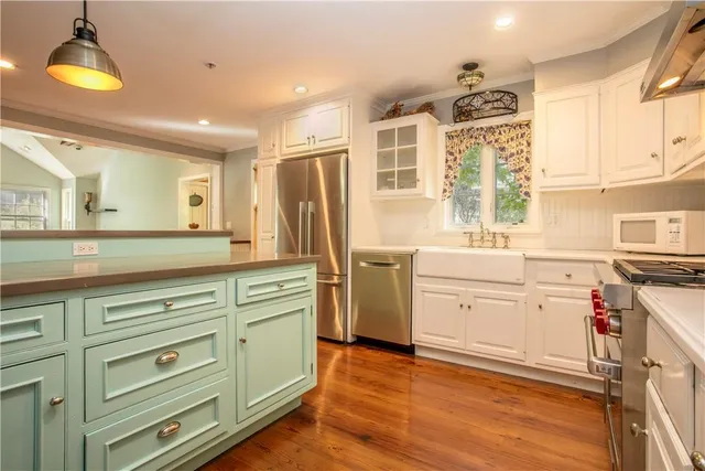 a kitchen with a stove a sink and a refrigerator