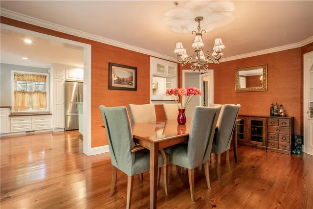 a view of a dining room with furniture wooden floor and chandelier