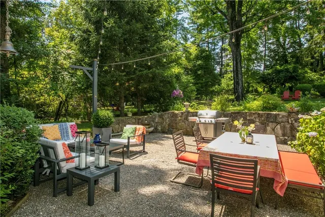 a view of a patio with table and chairs and potted plants