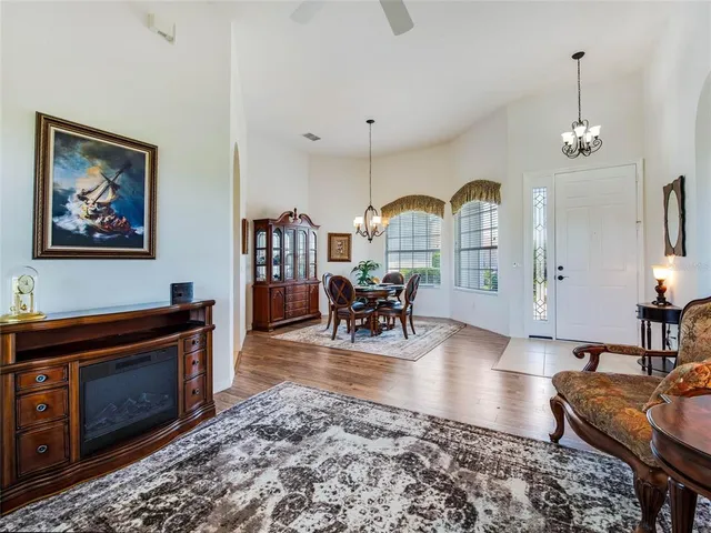 a living room with furniture a dining table and a fireplace