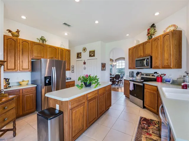 a kitchen with granite countertop a sink stove and refrigerator