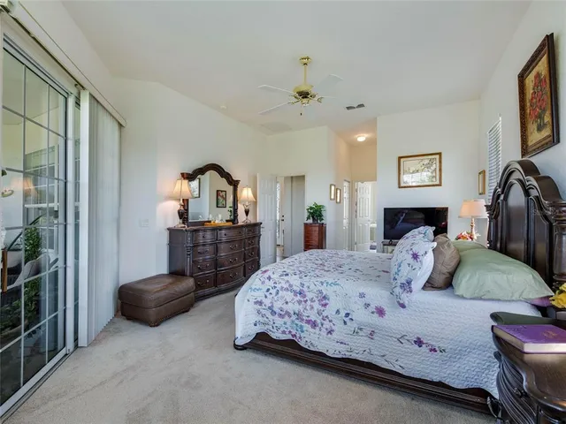a bedroom with a bed and dresser with mirror