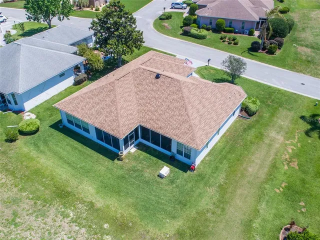 a aerial view of a house with yard and a garden