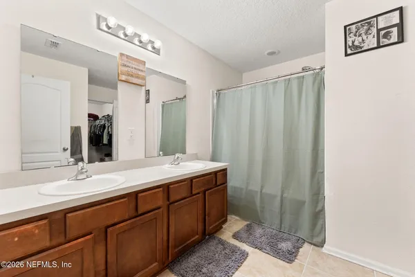 a bathroom with a double vanity sink and a mirror