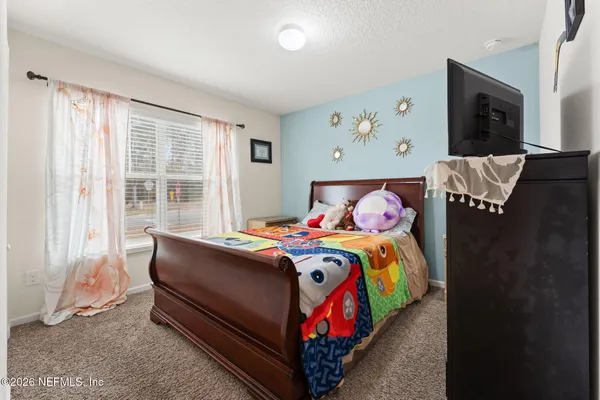 a bedroom with a bed and a couch