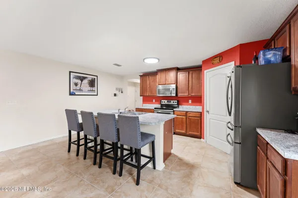 a kitchen with stainless steel appliances a refrigerator and a stove top oven