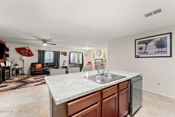 a kitchen with stainless steel appliances granite countertop a sink and a white cabinets