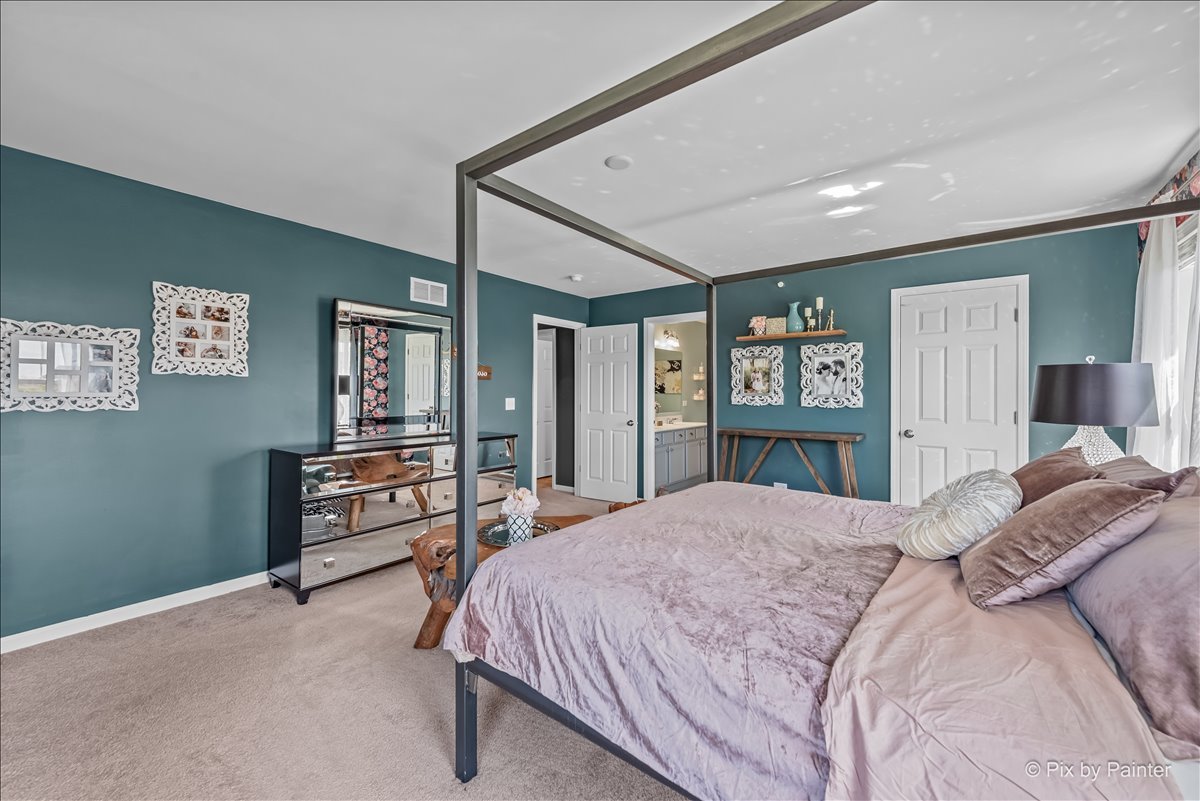 16207 West Switch Grass Road Lockport, IL 60441 - Photo 19 of 45 a bedroom with a bed dresser and a large mirror