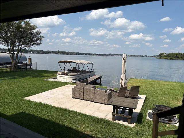 a view of a lake with table and chairs