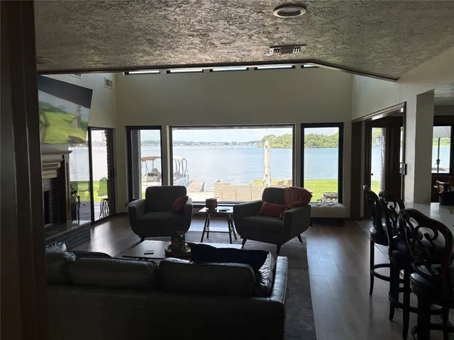 a living room with furniture and large windows