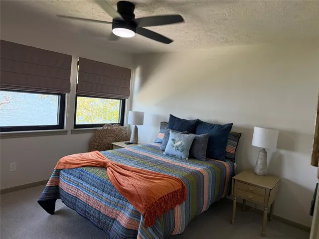 a bedroom with a bed and a tv