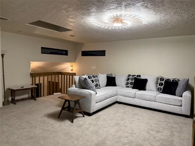a living room with furniture and a lamp