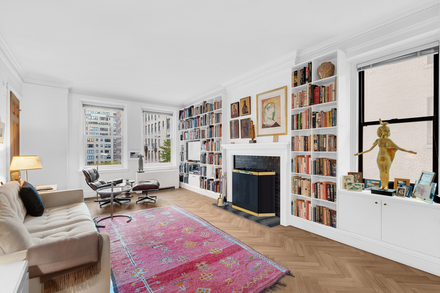 a living room with furniture a rug and a fireplace