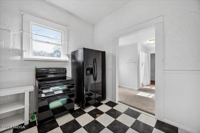 a view of a hallway with a black and white checkered floor