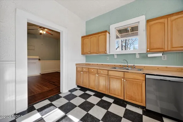 a kitchen with a sink a stove and cabinets