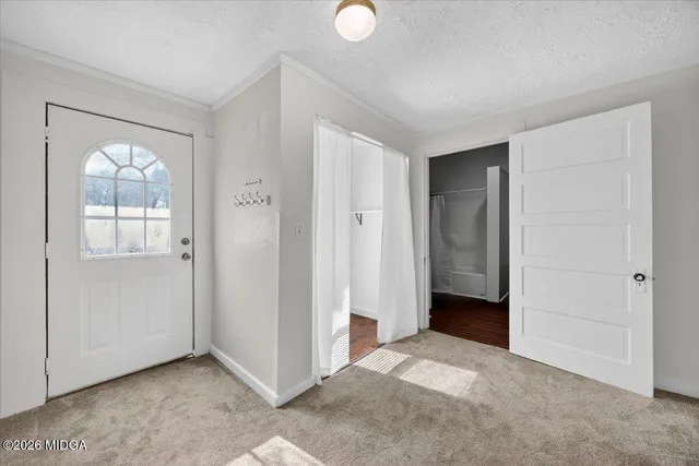 an empty room with windows and closet