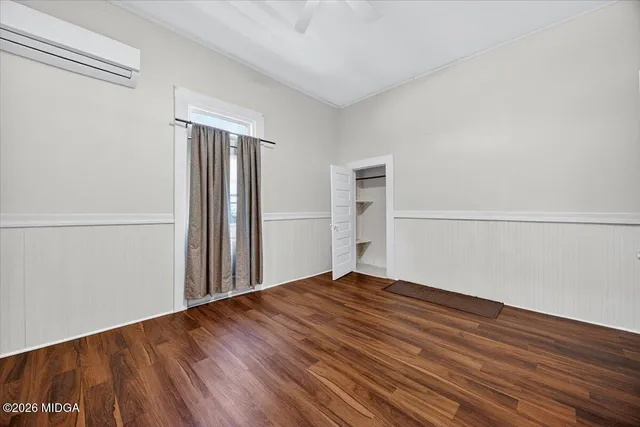 a view of empty room with wooden floor