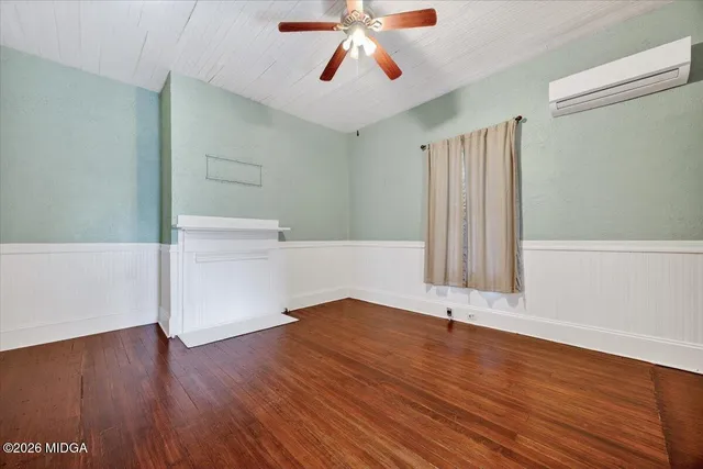 wooden floor in an empty room with a window