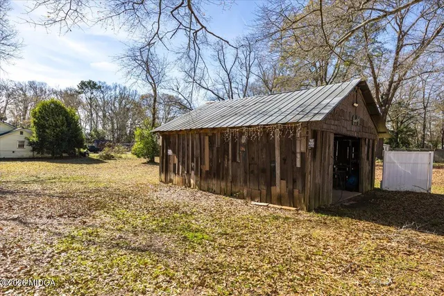a view of a house with a yard covered with snow