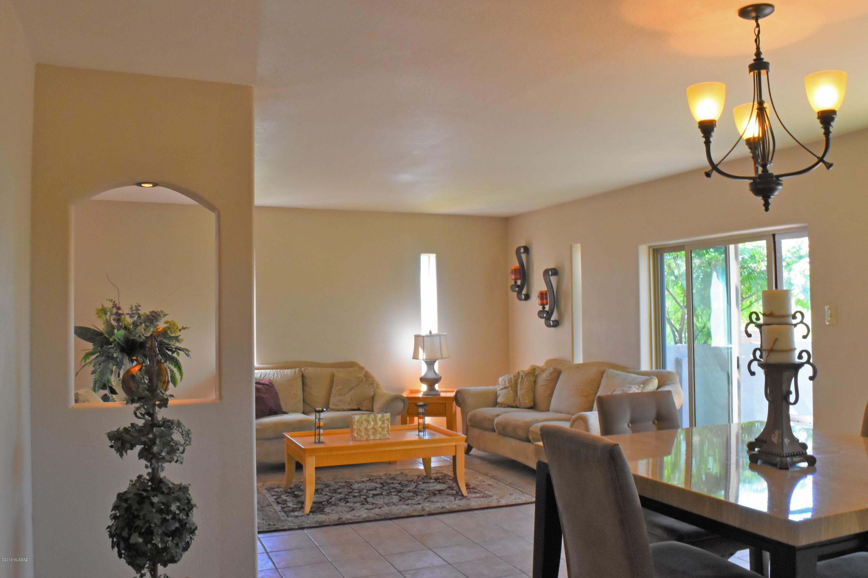392 Willow Drive Rio Rico, AZ 85648 - Photo 4 of 25 a living room with furniture a chandelier and a mirror