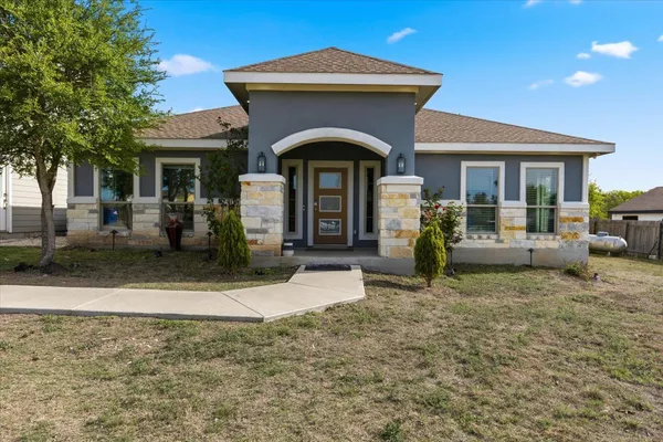 a front view of a house with garden