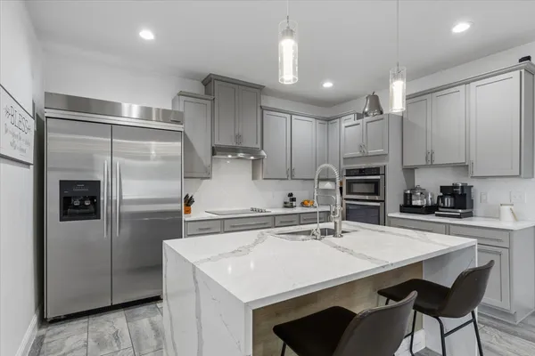 a bathroom with a double vanity sink mirror and bathtub